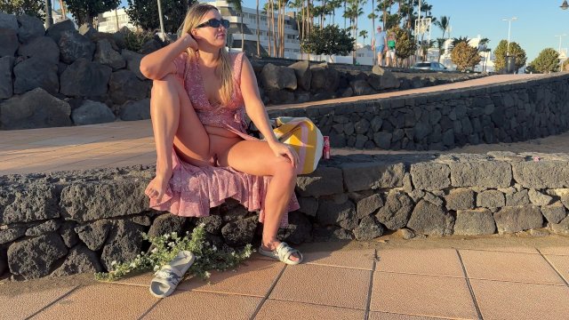 the girl lifted her skirt and opened her legs showing her pussy on the street
