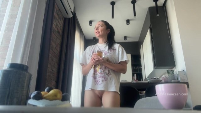 Sexy fit brunette does housework without panties.