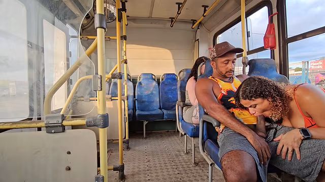 A shameless couple having sex on the bus while a female passenger in the seat behind films it all.