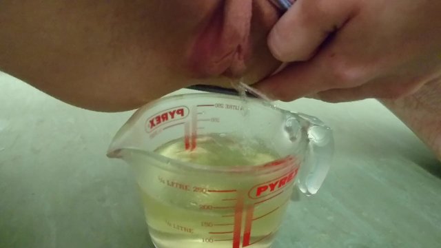 pee in measuring cup  close up
