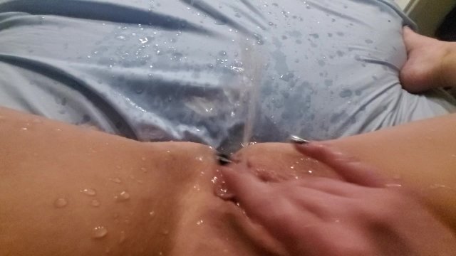 Fingering pussy, huge squirt leaves puddle in amateur bed
