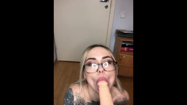 A blonde in a checkered skirt sucked a strap-on