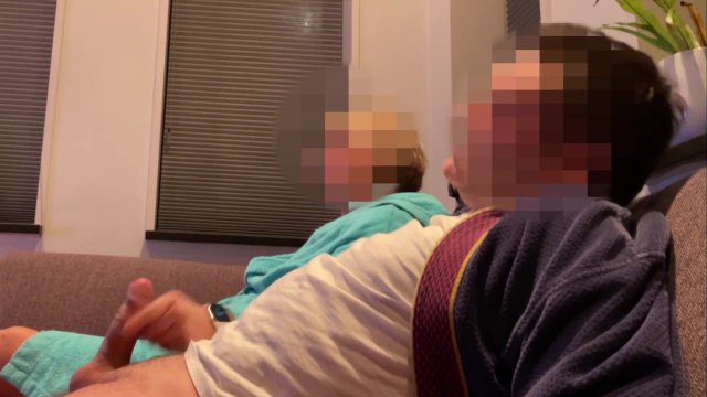 Casual handjob from wife while watching tv on couch
