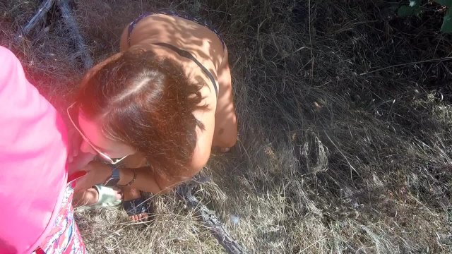 Quick fuck in the bushes with friend's stepmom while her stepson is walking on the beach